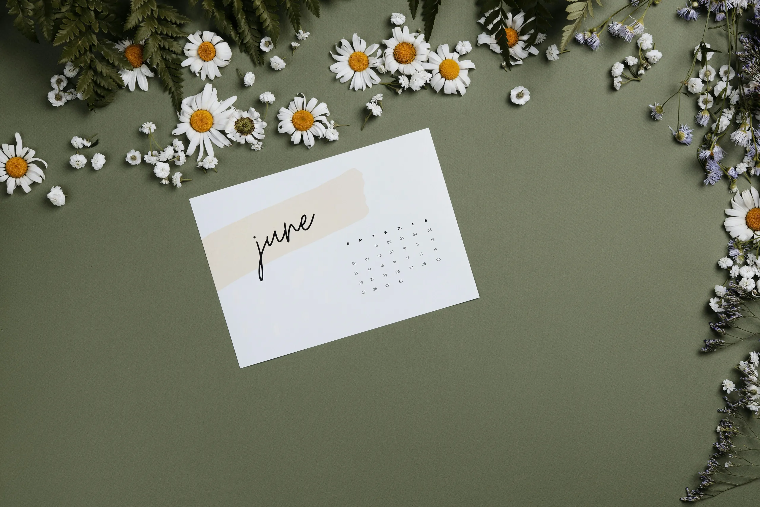 Calendar card displaying June surrounded by flowers