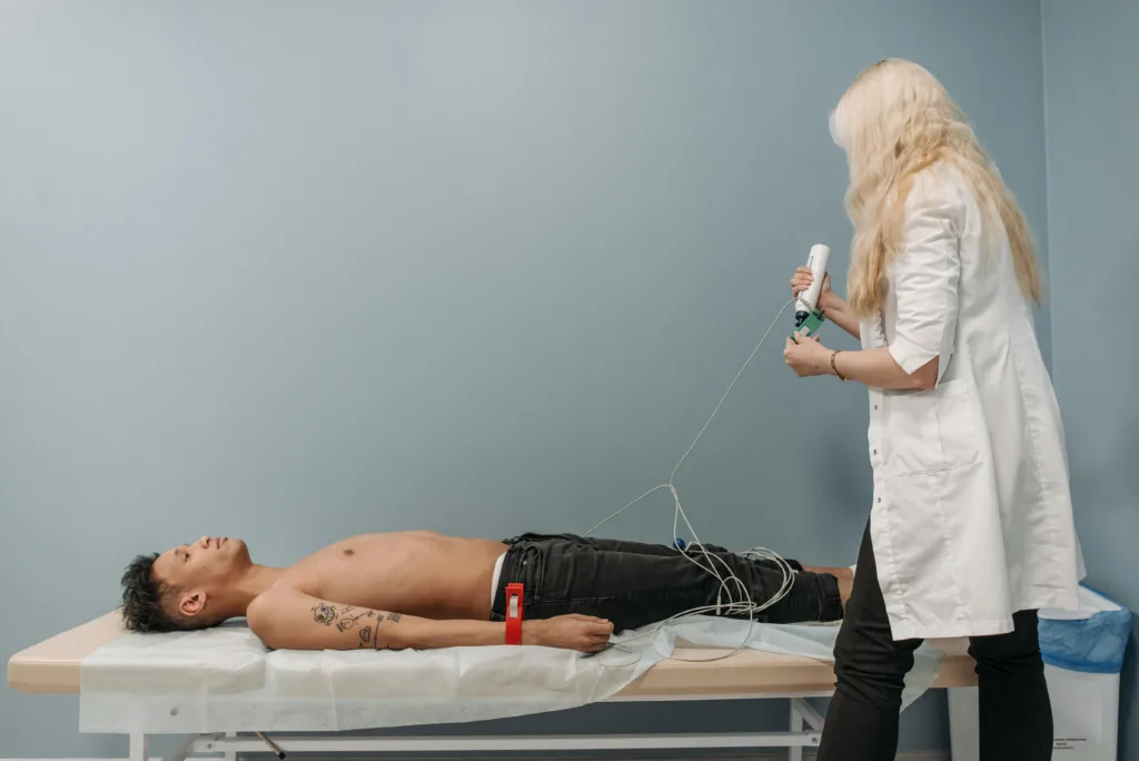 Clinician performing a diagnostic test on a patient lying on an examination table