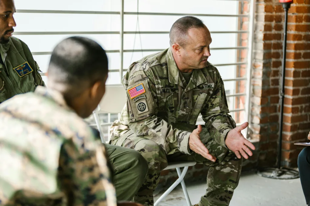 Group of people in military uniform in a discussion setting