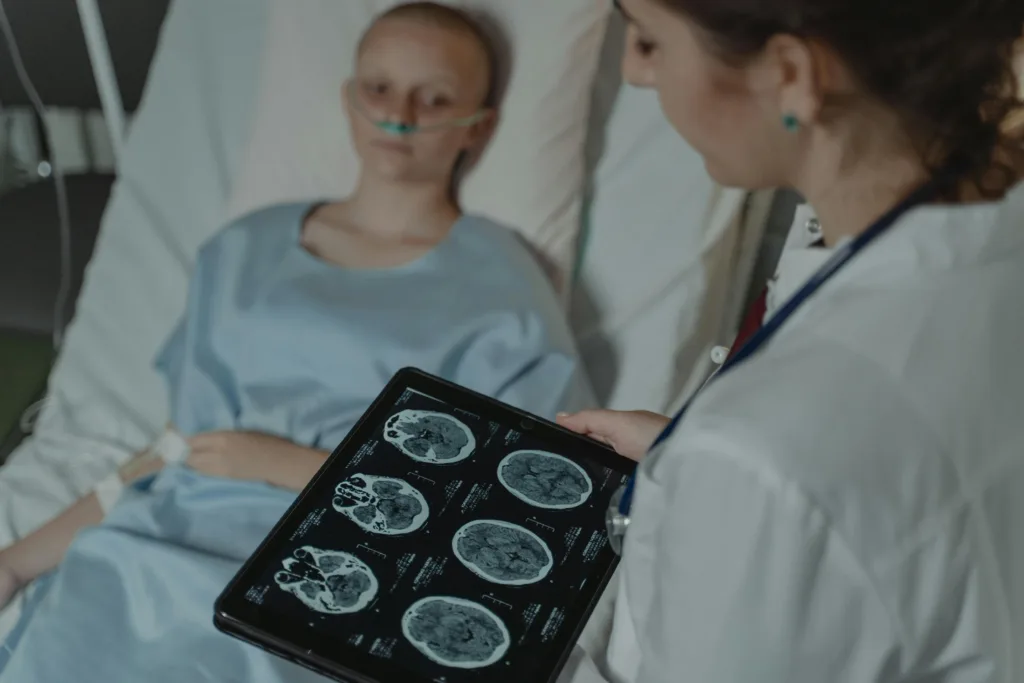Healthcare professional showing brain scan images to patient in bed
