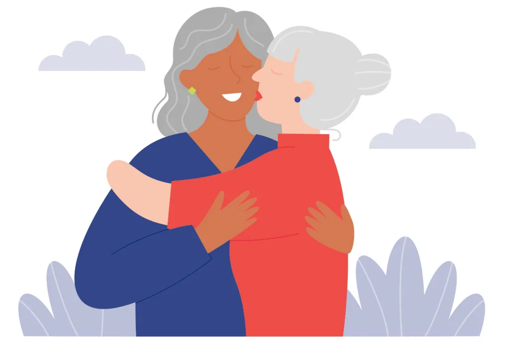 A graphic of two grey haired ladies embracing. One is kissing the other on the cheek, and the other is smiling.
