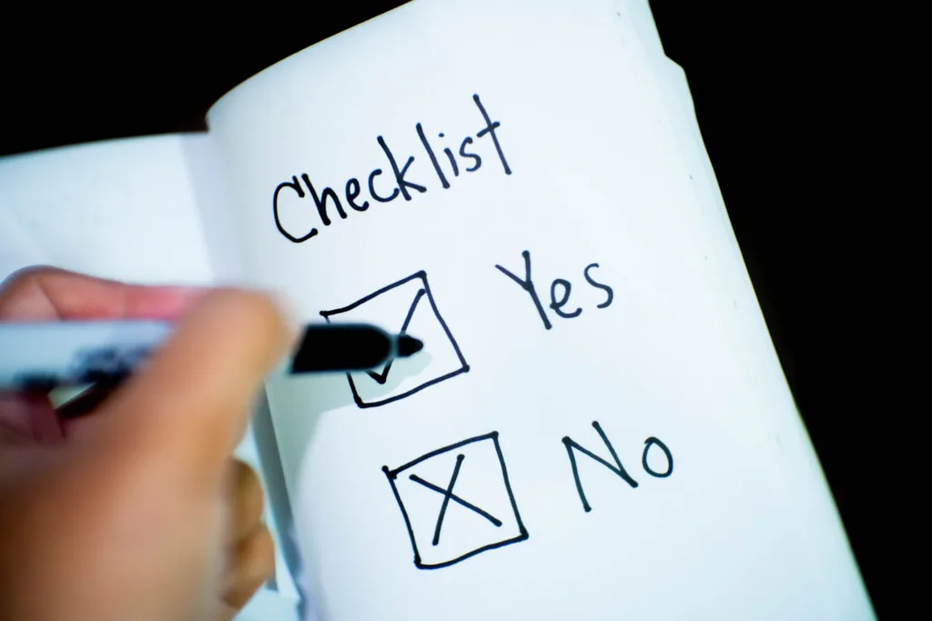 A notebook featuring a checklist with a marked 'Yes' box, captured in a close-up shot