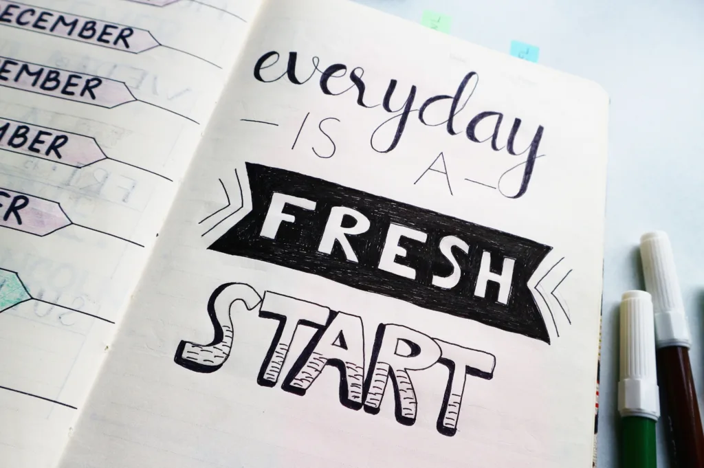 Notebook page featuring motivational quote 'Everyday is a fresh start' with colourful pens