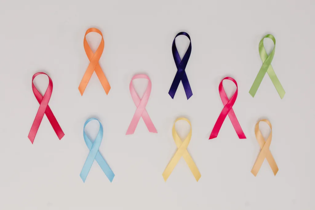 A collection of colourful awareness ribbons symbolising various causes on a white background