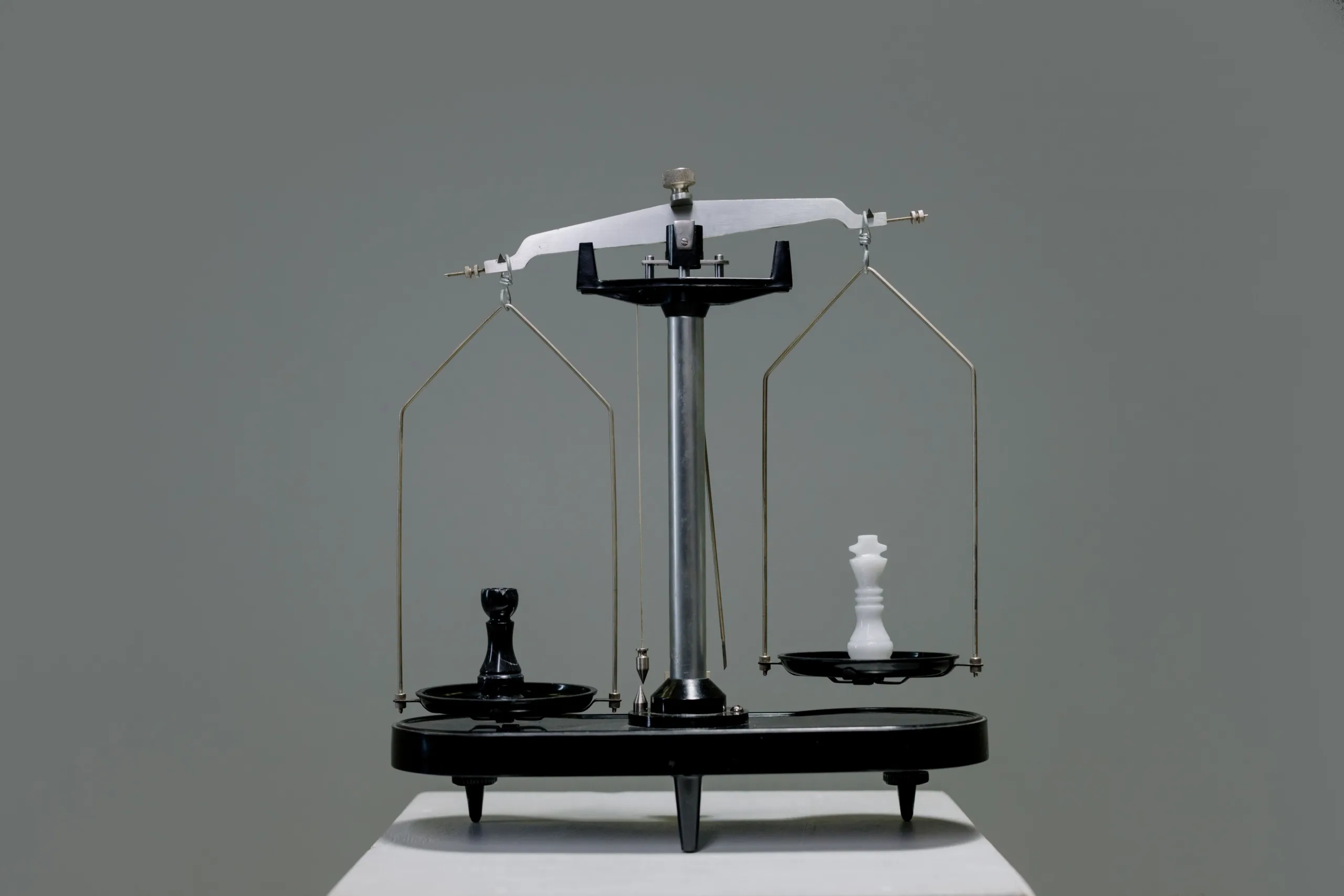 Chess pieces balanced on a scale depicting equality or strategy in decision making