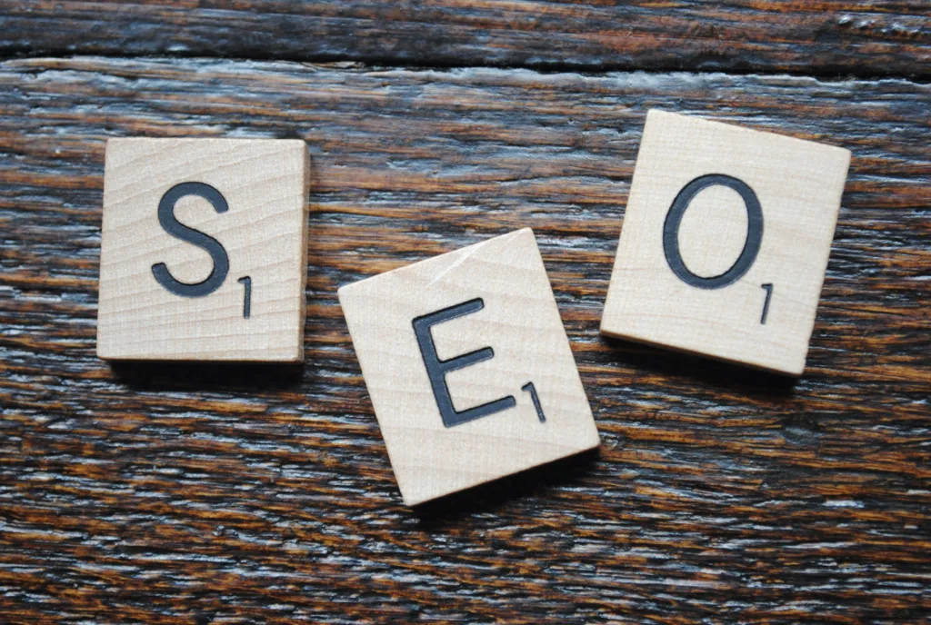 Close-up of Scrabble tiles spelling SEO on a wooden table for content strategy