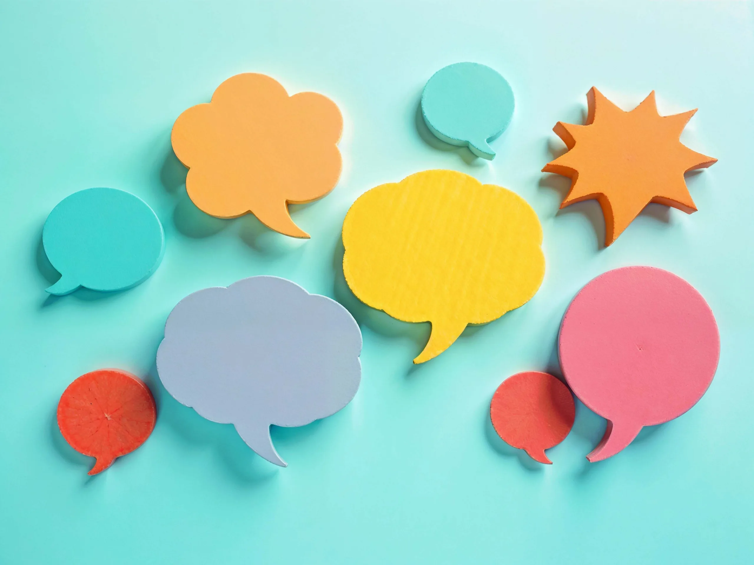 Brightly coloured speech bubbles on a light blue background.