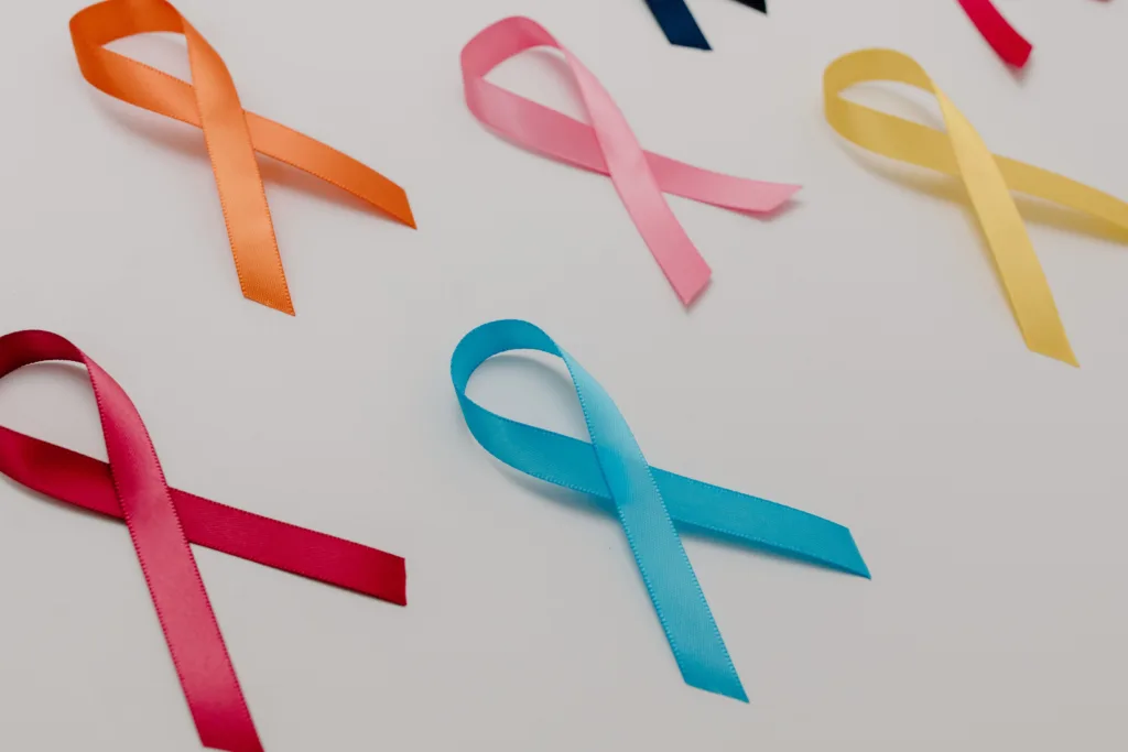 Various coloured ribbons representing different awareness causes on a white surface.
